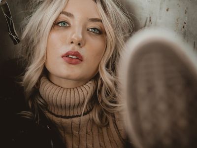 Woman in a relaxed pose with eyes closed.
